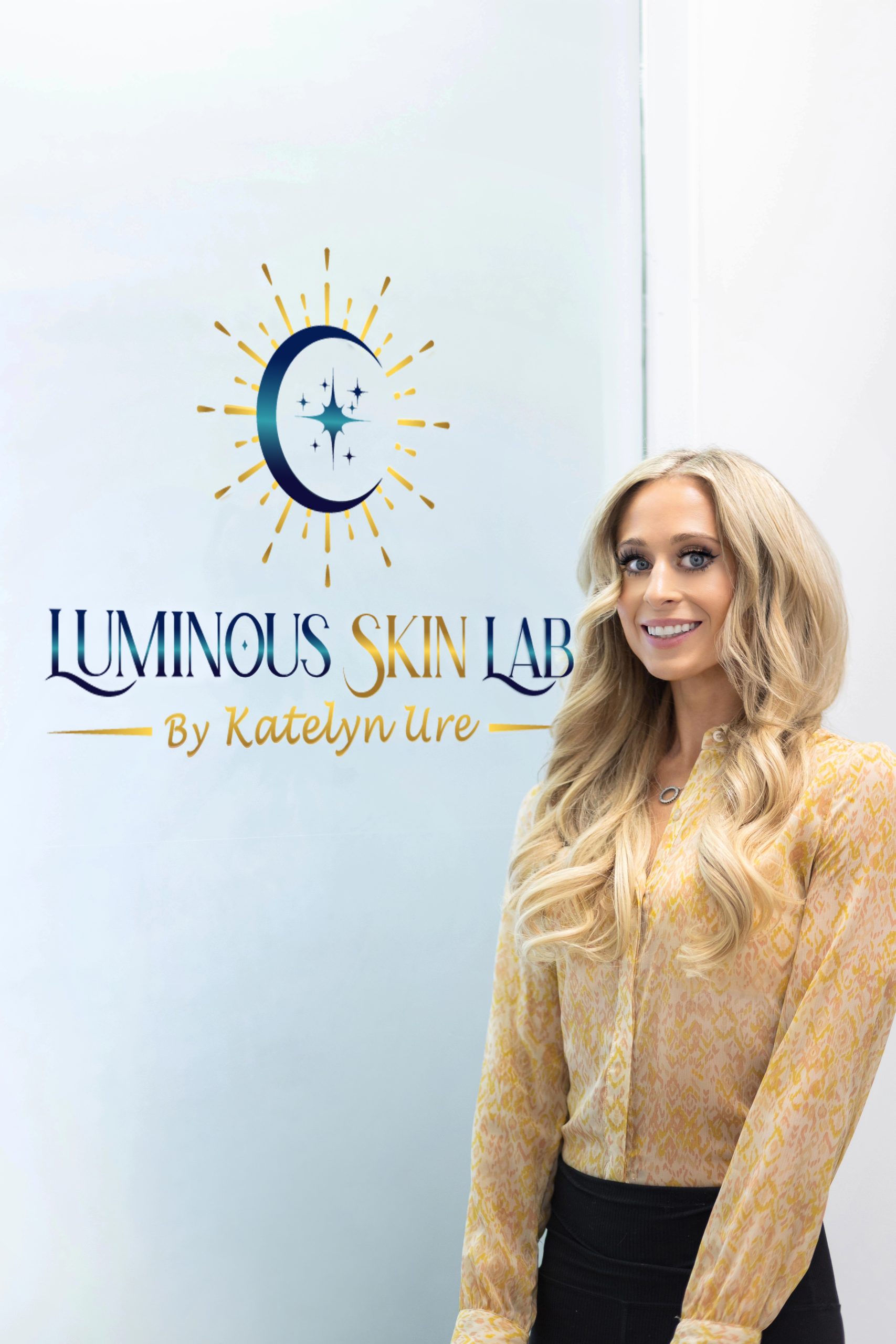 Katelyn with Luminous Skin Lab Sign